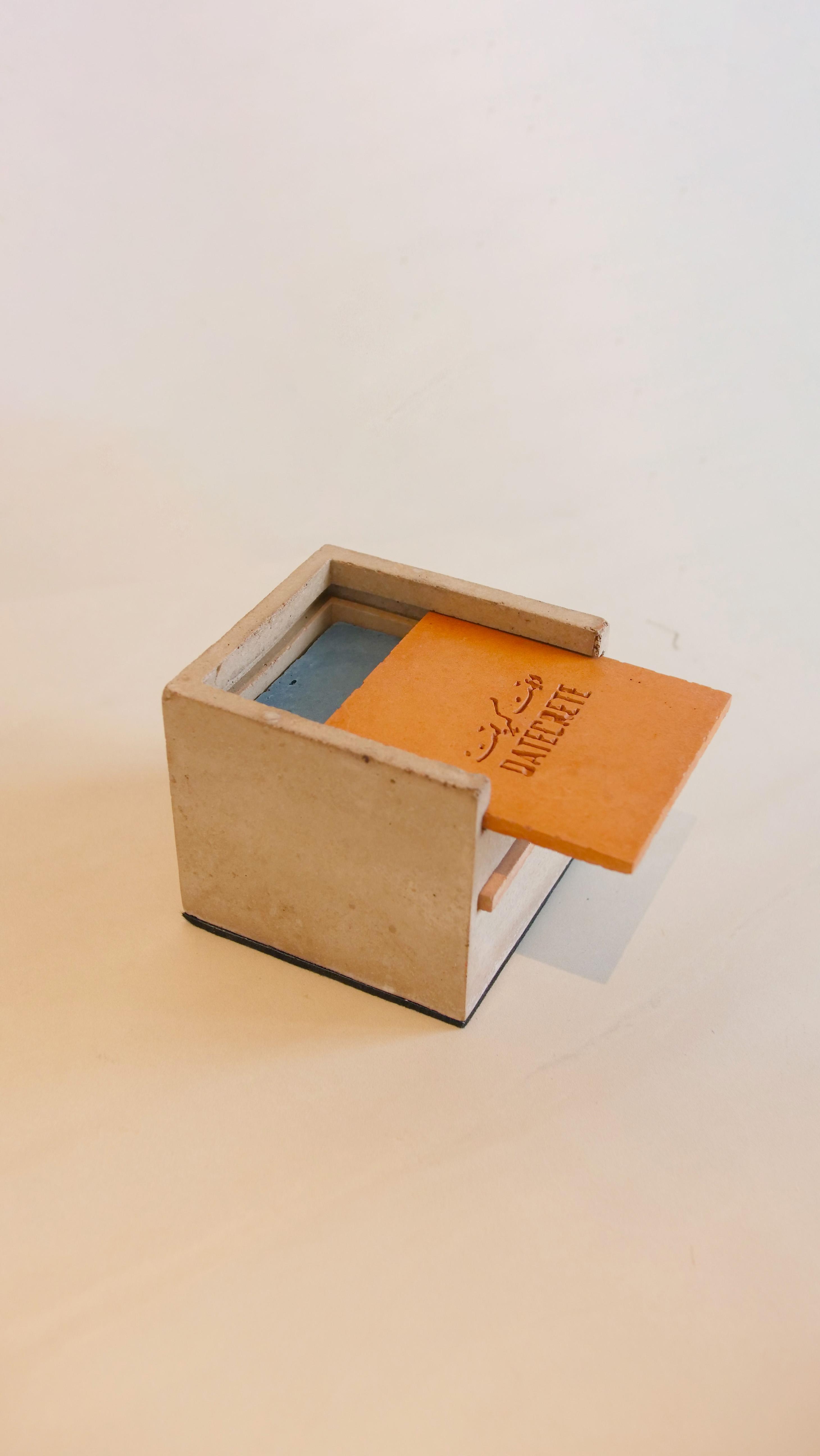 High angle shot of the Datecrete sample box with the lid slightly open.