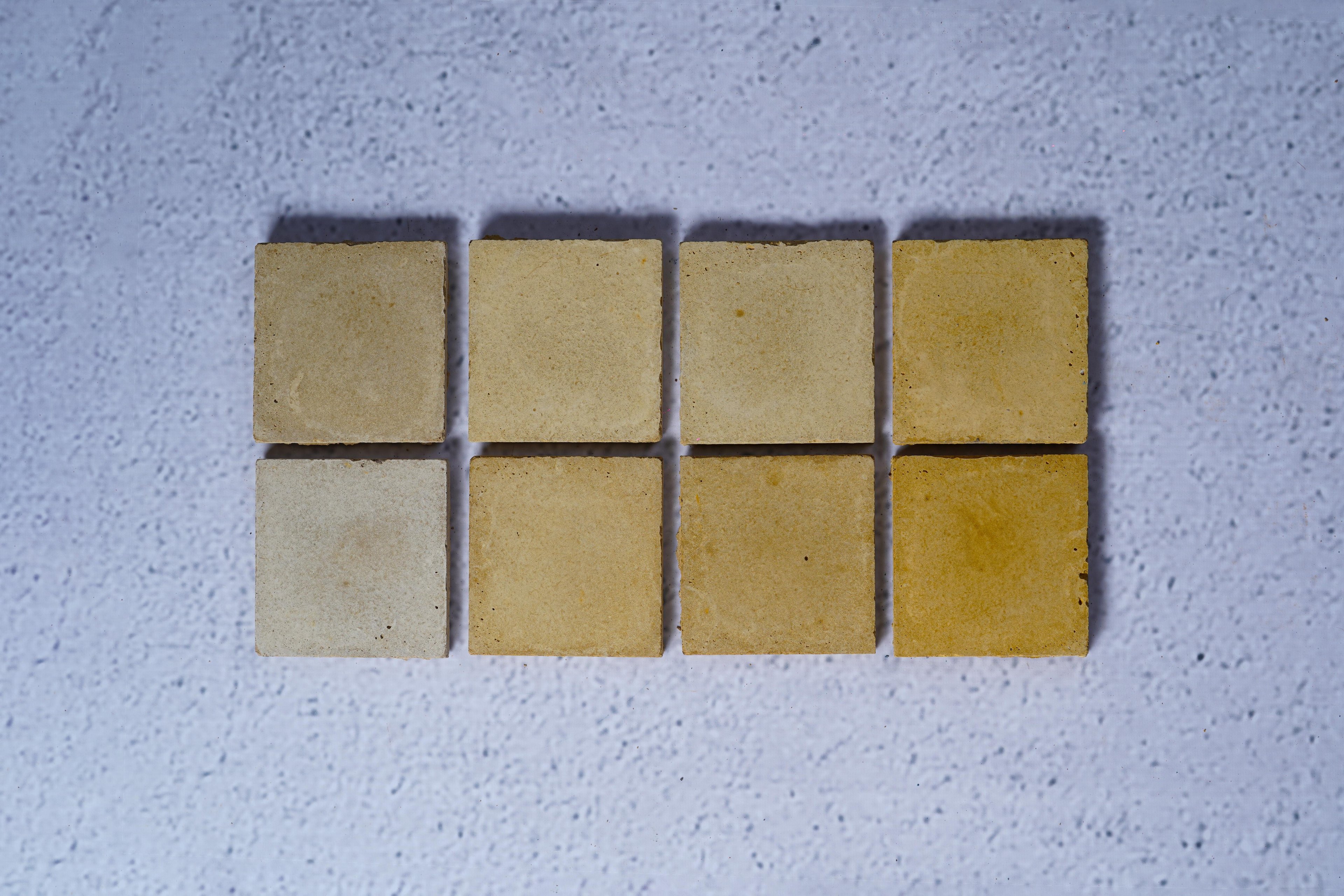 2 rows of 4 bricks in the style Misted Yellow, with the first row showing the raw finish and the second showing the enhanced.